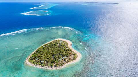 Tavarua is a heart shaped island resort in Fiji known for its seven main surfing breaks. The island hosts annual professional surfing competitions. (Matteo Colombo/ Digital Vision via Getty Images)