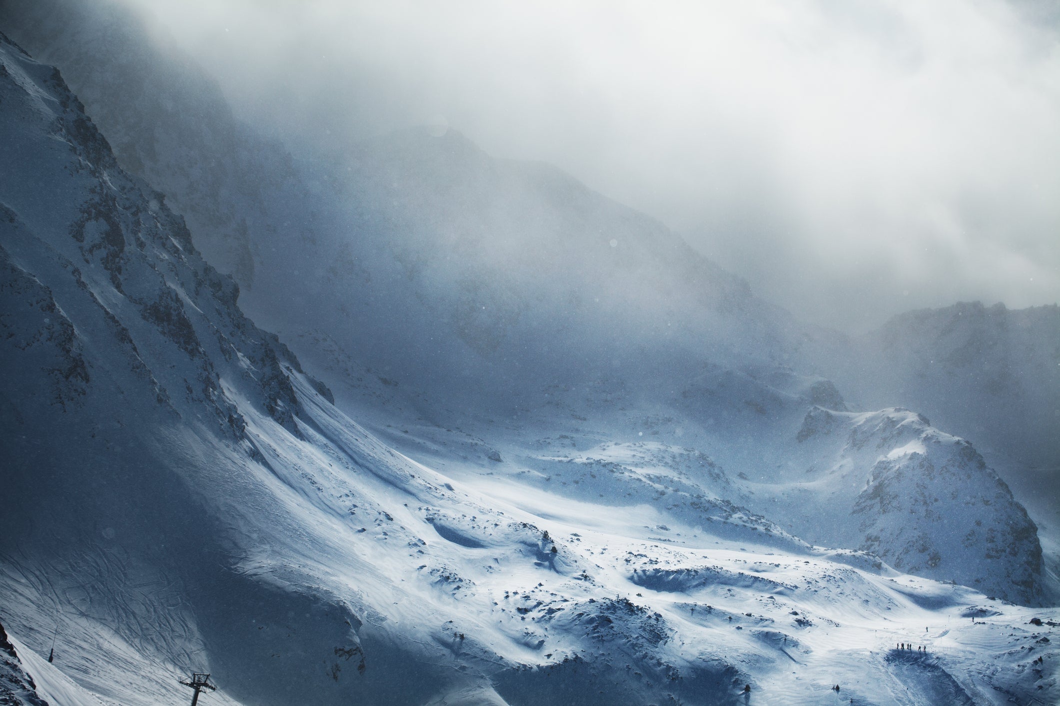 Aerial view of snowy mountains at winter day. Stormy weather, Canillo ski region, Andorra