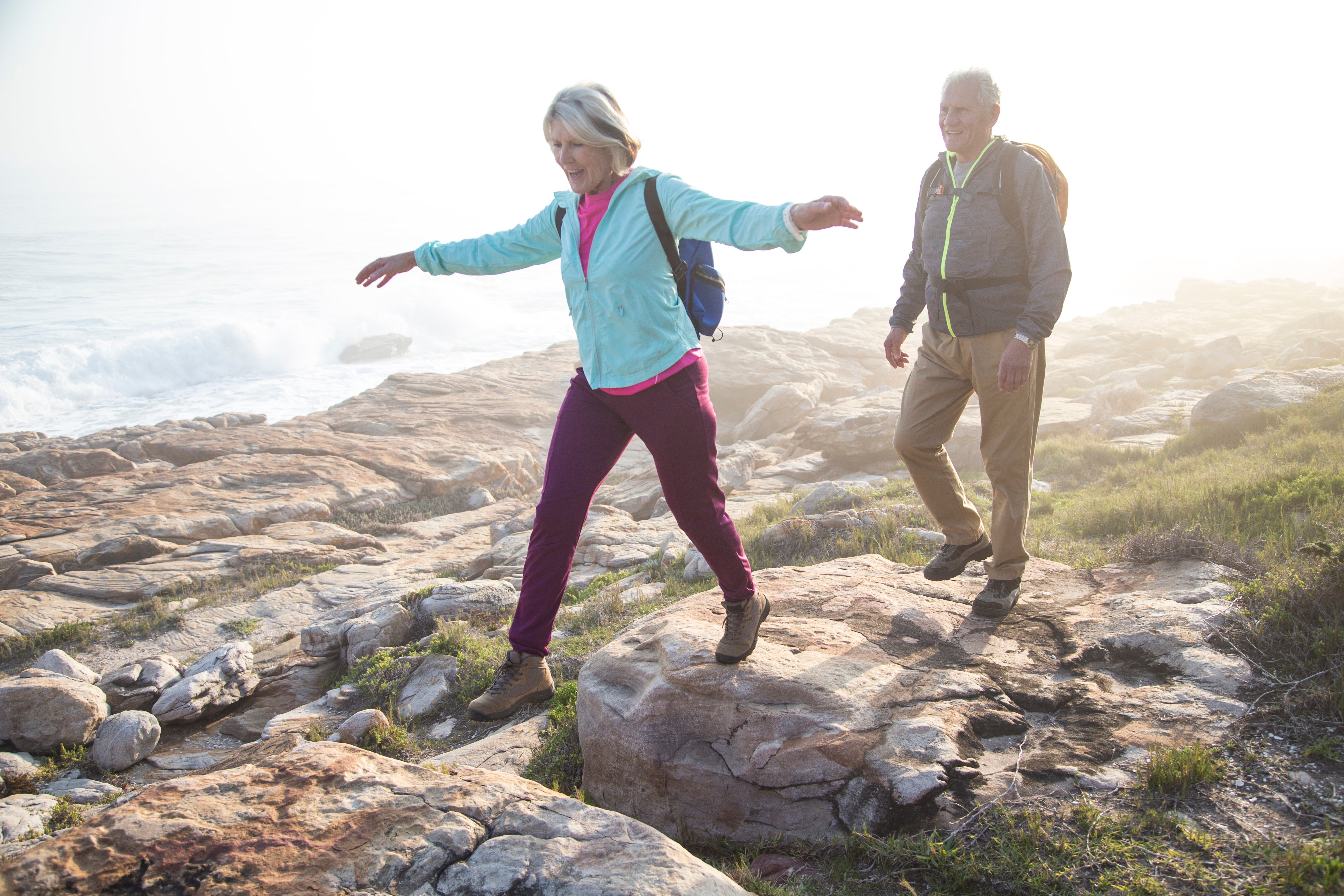 A couple hikes in layered clothing. (Alistair Berg/Getty Images)
