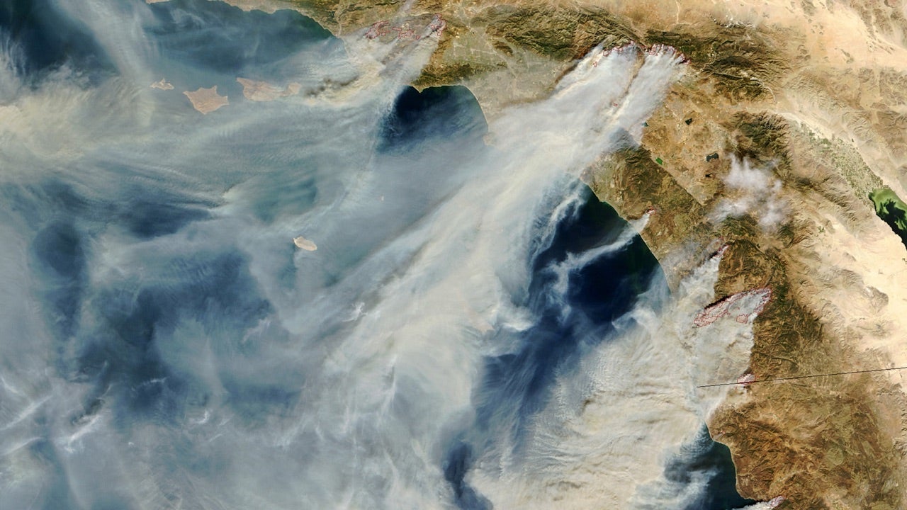 Several massive wildfires were raging across southern California over the weekend of October 25, 2003. Whipped by the hot, dry Santa Ana winds that blow toward the coast from interior deserts, at least one fire grew 10,000 acres in just 6 hours. (Compare this scene with one captured by Aqua MODIS just one day before.) The Moderate Resolution Imaging Spectroradiometer (MODIS) on the Terra satellite captured this image of the fires and clouds of smoke spread over the region on October 26, 2003.   Moving northwest to southeast along the coast, the first cluster of red dots is a combination of the Piru, Verdale, and Simi Incident Fires; the next cluster?to the east of Los Angeles?is the Grand Prix (west) and Old (east) Fires; to their south is the Roblar 2 Fire; next is the Paradise Fire; then the massive Cedar Fire, whose thick smoke is completely overshadowing the coastal city of San Diego; finally, at the California-Mexico border is the Otay Fire. At least 13 people have lost their lives because of these fires (Photo by NASA/WireImage) *** Local Caption ***