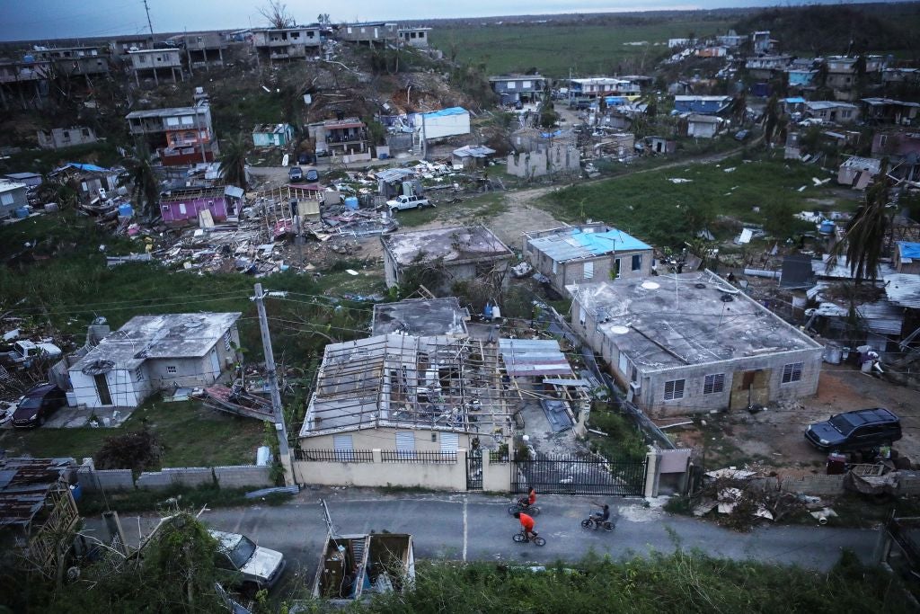 SAN ISIDRO, PUERTO RICO - OCTOBER 05:  Kids bike in an area without grid power or running water about two weeks after Hurricane Maria swept through the island on October 5, 2017 in San Isidro, Puerto Rico. Puerto Rico experienced widespread damage including most of the electrical, gas and water grid as well as agriculture after Hurricane Maria, a category 4 hurricane, swept through.  (Photo by Mario Tama/Getty Images)