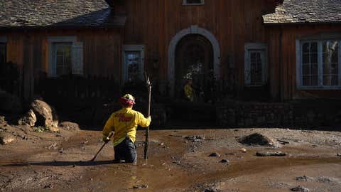 MONTECITO, CALIFORNIA JANUARY 10, 2018-Cal Firefighter Alex Jimenez marks the spot where he just found a body under the mud at a house along Glen Oaks Drive in Montecito after a major storm hit the burn area Wednesday. (Wally Skalij/Los Angeles Times)