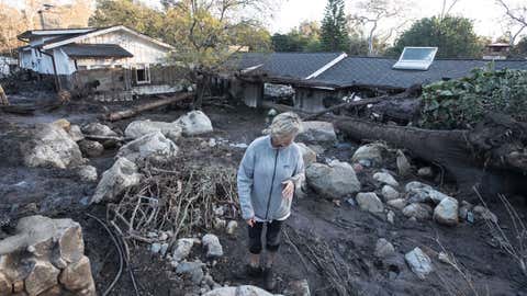 MONTECITO, CALIF. -- THURSDAY, JANUARY 11, 2018: Teresa Drenick looks over what is left of her sister Rebecca Riskin's home on Glen Oaks Drive along San Ysidro Creek in Montecito, Calif., on Jan. 11, 2018. Risking was killed in the mudslide. (Brian van der Brug / Los Angeles Times)