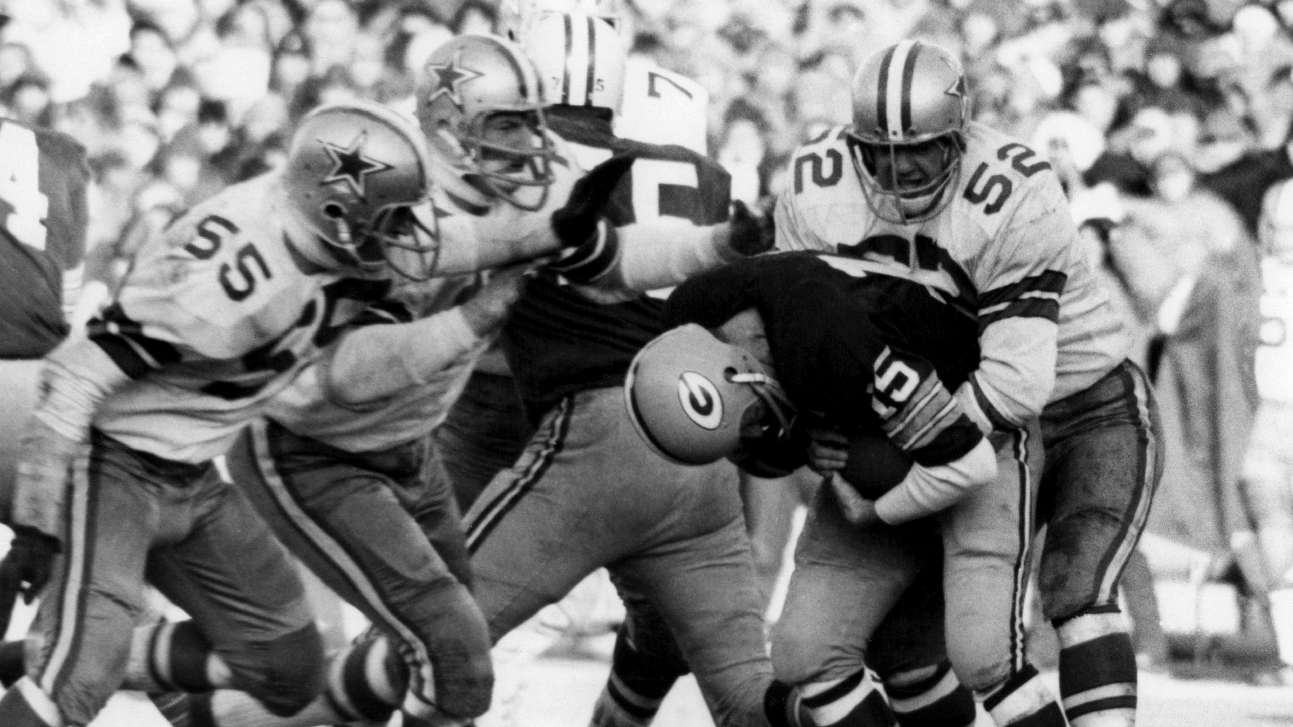 GREEN BAY, WI - DECEMBER 31:  Quarterback Bart Starr #15 of the Green Bay Packers is tackled by Dave Edwards #52 and Lee Roy Jordan #55 of the Dallas Cowboys during the 1967 NFL Championship Game on December 31, 1967 at Lambeau Field in Green Bay, Wisconsin.  The game would be known as the "Ice Bowl".  (Photo by Bruce Bennett Studios via Getty Images Studios/Getty Images)