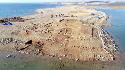 Climate Change-Induced Droughts in Iraq Lead to Reemergence of 3400-Year-Old Submerged City 1 Aerial view of the excavations at Kemune with Bronze Age architecture partly submerged in the lake. (University of Tübingen)