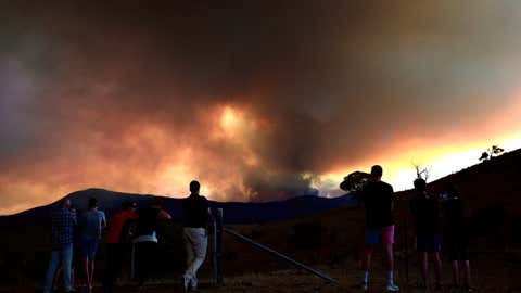 People look at a bushfire at the Namadgi National Park in Canberra, Australia on January 28, 2020. (Chu Chen/Xinhua/IANS)