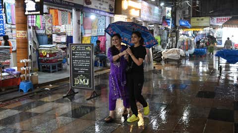 Passengers walking with an umbrella in the rain in Bhopal (A Moeed Faruqui/BCCL - BHOPAL/BCCL - TOI DIGITAL EDITORIAL DEPARTMENT)