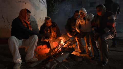 People have resorted to burning wood to beat the cold in Lucknow. 