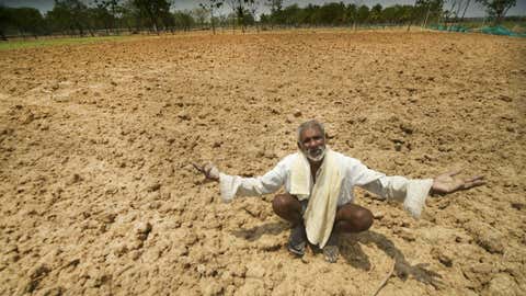 File photo of a 60-year-old farmer, Kulla Shetty, sitting in the middle of his dried agriculture land cursing the rain god near Mysuru, Karnataka (Netra Raju and S Nagendra / BCCL)