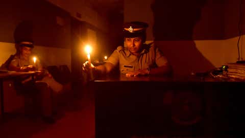 Police officers observe Earth Hour while on duty at the women’s police station in Kozhikode, Kerala. (E Gokul/BCCL Kozhikode)