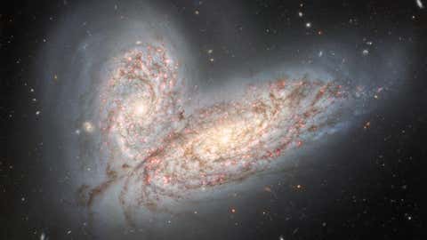 Gemini North telescope in Hawai‘i reveals a pair of interacting spiral galaxies — NGC 4568 (bottom) and NGC 4567 (top) — as they begin to clash and merge (International Gemini Observatory/NOIRLab/NSF/AURA)