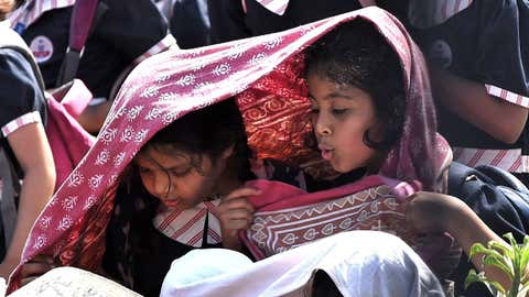 On a hot February day, school students take shelter from the scorching sun.  (Suman Reddy D/BCCL Hyderabad)