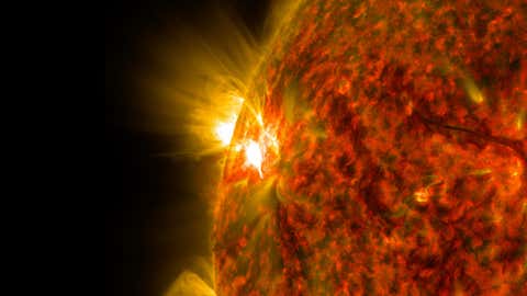 File photo: The bright flash of an M-class flare is seen exploding on the left side of the sun in this image from Nov. 5, 2014. The image was captured by NASA's Solar Dynamics Observatory in extreme ultraviolet light that was colorized in red and gold.(NASA/SDO)