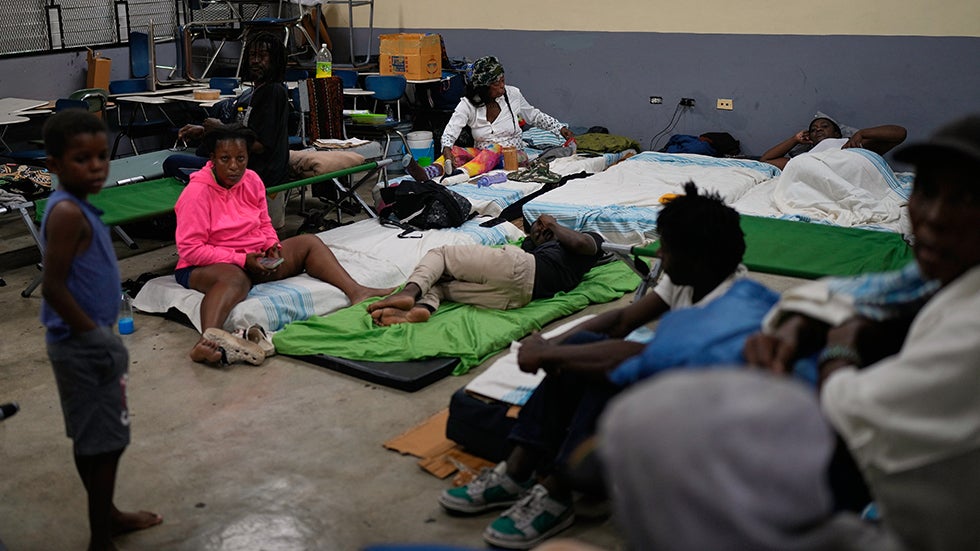 People take shelter in a school ahead of Hurricane Melissa's forecast arrival in Old Harbour, Jamaica, Monday, Oct. 27, 2025. (AP Photo/Matias Delacroix)