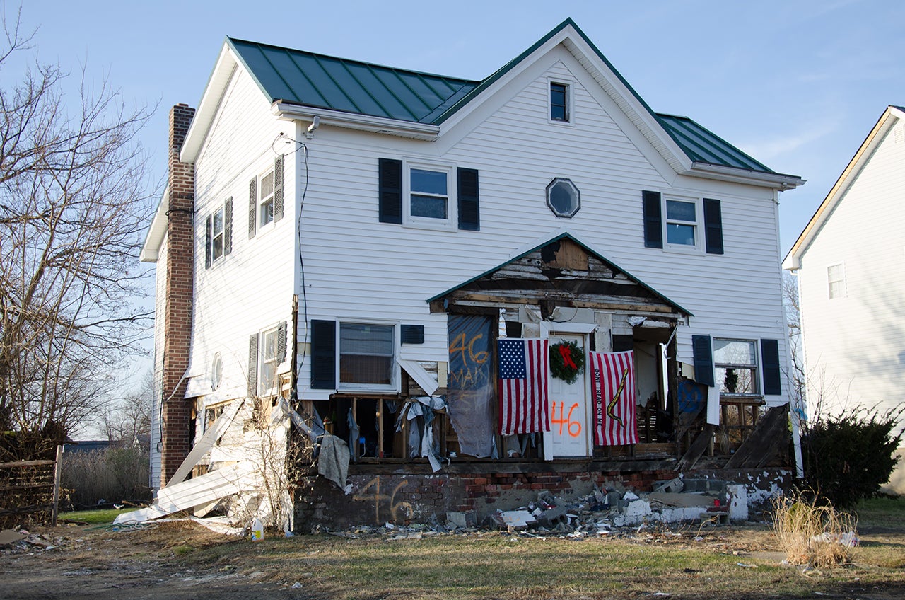 A house that was damaged by Superstorm Sandy sits decorated for the holidays in Dec. 2012 in the Port Monmouth neighborhood of Middletown, N.J. (Liz Roll/weather.com)
