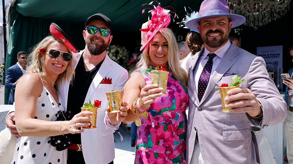 LOUISVILLE, KY - MAY 04: Horse racing fans hold up their mint julep drinks while attending the 150th Kentucky Derby on May 04, 2024 at Churchill Downs in Louisville, Kentucky. (Photo by Joe Robbins/Icon Sportswire via Getty Images)