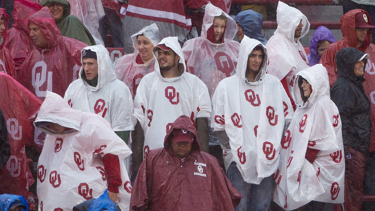 November 22, 2014: Oklahoma Sooners student fans try to stay dry while it pours rain during the NCAA Big 12 football game between the Kansas Jayhawks and the Oklahoma Sooners at Gaylord Family Memorial Stadium in Norman, Oklahoma. (Photo by William Purnell/Icon Sportswire/Corbis/Icon Sportswire via Getty Images)