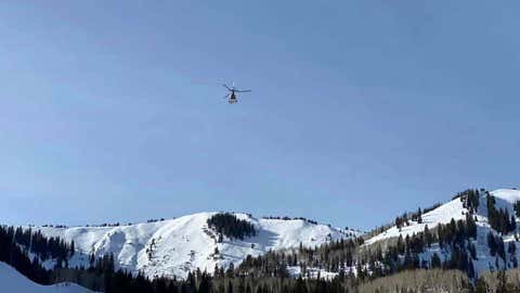 A helicopter flies over the area where an avalanche occurred in the backcountry outside of the Park City Mountain Resort ski area on Friday, Jan. 8, 2021. A man who ventured outside of the resort to snowboard was killed in the avalanche. (Park City Fire District via Facebook)