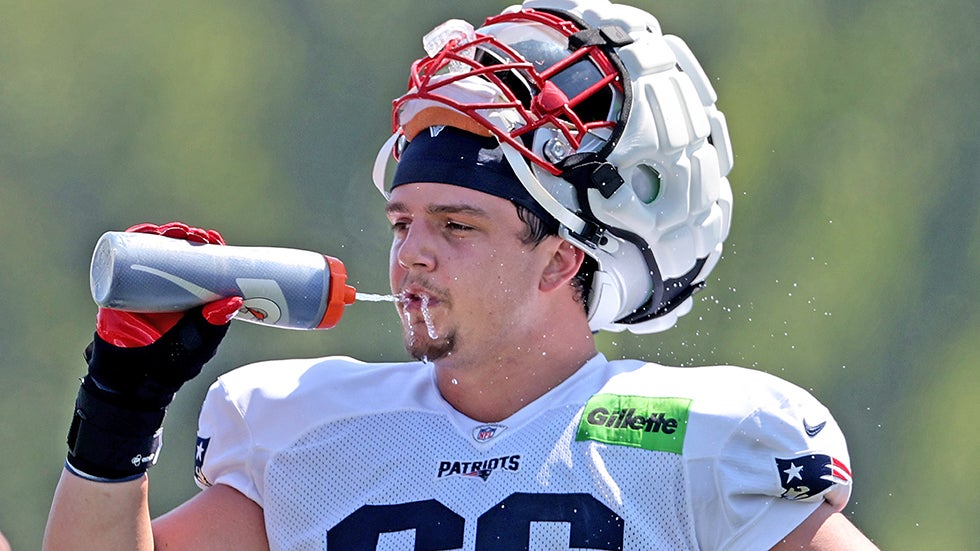Foxboro, MA - July 28 - Offensive tackle Will Campbell (66) of the New England Patriots hydrates during a hot Training Camp at Gillette Stadium.  (Photo by Matt Stone/MediaNews Group/Boston Herald via Getty Images)