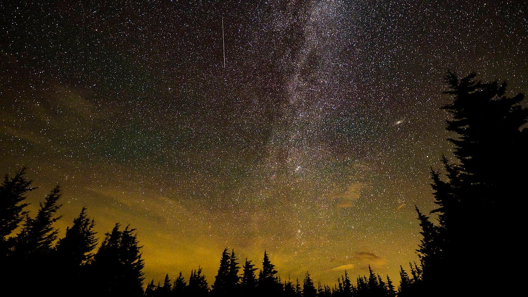 In this 30 second exposure, a meteor streaks across the sky during the annual Perseid meteor shower, Tuesday, Aug. 10, 2021, in Spruce Knob, West Virginia. Photo Credit: (NASA/Bill Ingalls)