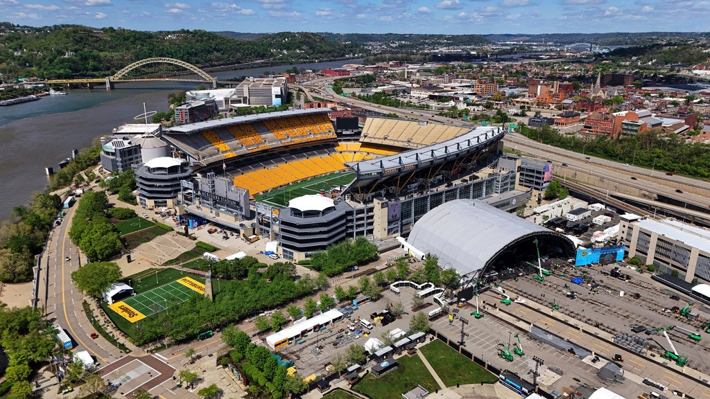 This is the Acrisure Stadium, left, and the adjacent 2026 NFL Draft stage on the Northside of Pittsburgh on Sunday April 19, 2026, four days before the first round of the 2026 NFL Draft in Pittsburgh. (AP Photo/Gene J. Puskar)