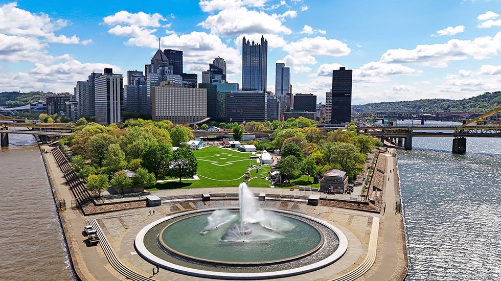 This is Point State Park, on Sunday, April 19, 2026, where a portion of the 2026 NFL Draft activities will be staged, across the Allegheny River from the NFL Draft stage built outside Acrisure Stadium in Pittsburgh. (AP Photo/Gene J. Puskar)