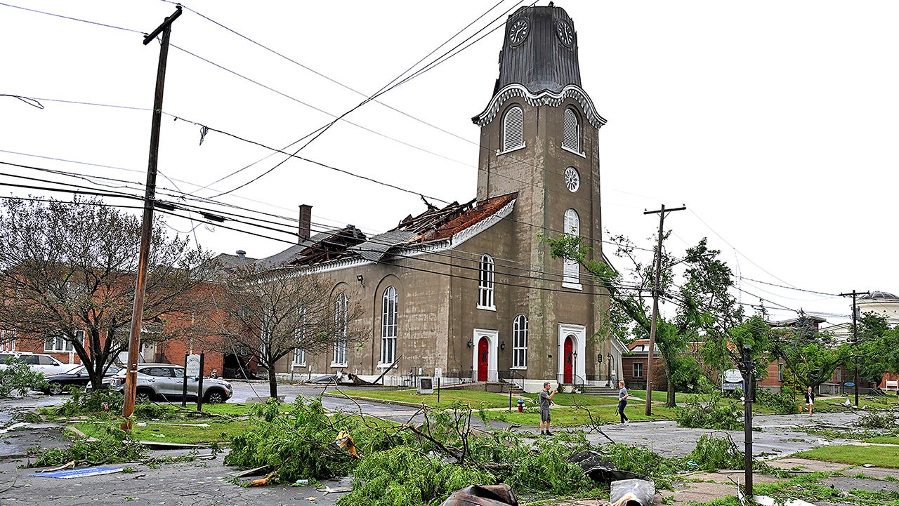People survey the collapsed roof and missing spire of the Rome First Presbyterian Church, and downed trees from a tornado, in Rome, N.Y., Tuesday, July 16, 2024. 