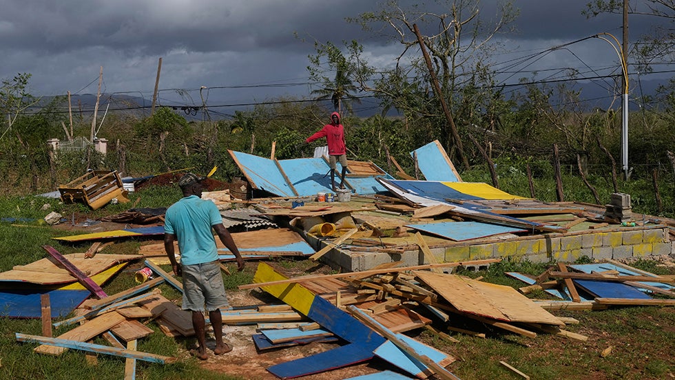 SANTA CRUZ, JAMAICA: Residents stand on the wreckage of a house destroyed by Hurricane Melissa on Wednesday, Oct. 29, 2025. (AP Photo/Matias Delacroix)