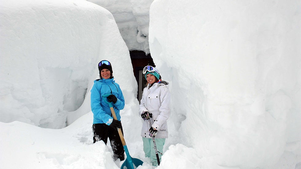 Penny Pritchard, left, and Christina Medefesser take a break outside their west end Donner Lake home Friday March 26, 2011. The two had a huge job ahead of digging out their two cars, not to mention their home. 3.25.2011. AP Photo/Reno Gazette-Journal,Tim Dunn