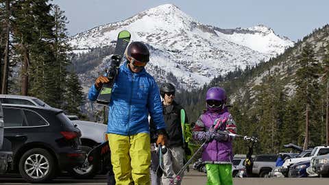 Bret McTigue, left, and his daughter Taylor, 8, head to the slopes at Sierra-at-Tahoe Ski Resort, Wednesday, Jan. 3, 2018, near Echo Summit, Calif. The California Department of Water Resources held the first snow survey of the season at the nearby Phillips Station that showed the snowpack at 1.3 inches of depth with a water content of .4 inches. California's water managers are saying it's too early yet for fears that the state is sliding back into its historic five-year drought. (AP Photo/Rich Pedroncelli)