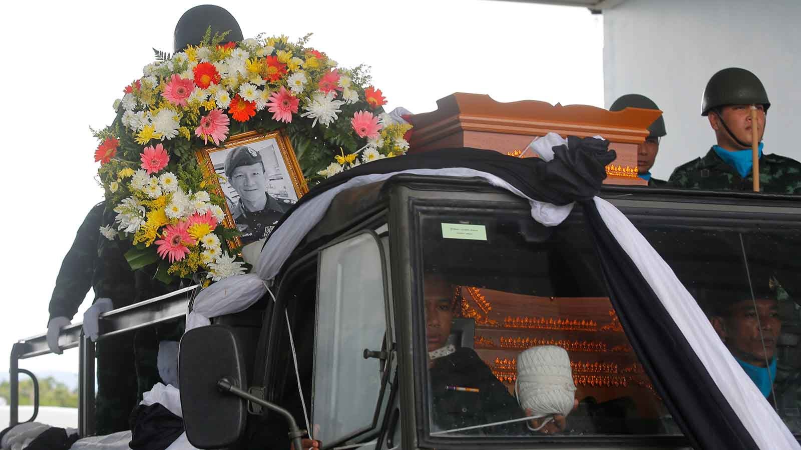 The body of Saman Gunan, a former Thai navy SEAL who died during an overnight mission, is carried during a repatriation and religious rites ceremony at Chiang Rai Airport in Mae Sai, Chiang Rai province, in northern Thailand Friday, July 6, 2018. The Thai navy diver working as part of the effort to rescue 12 boys and their soccer coach trapped in a flooded cave died Friday from lack of oxygen, underscoring risks of extracting the team. (AP Photo) 
