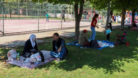 People rest in a public park outdoors away from buildings following an earthquake in Malatya, southern Turkey, Wednesday, Oct. 16, 2024. (Burhan Karaduman/Dia Photo via AP)