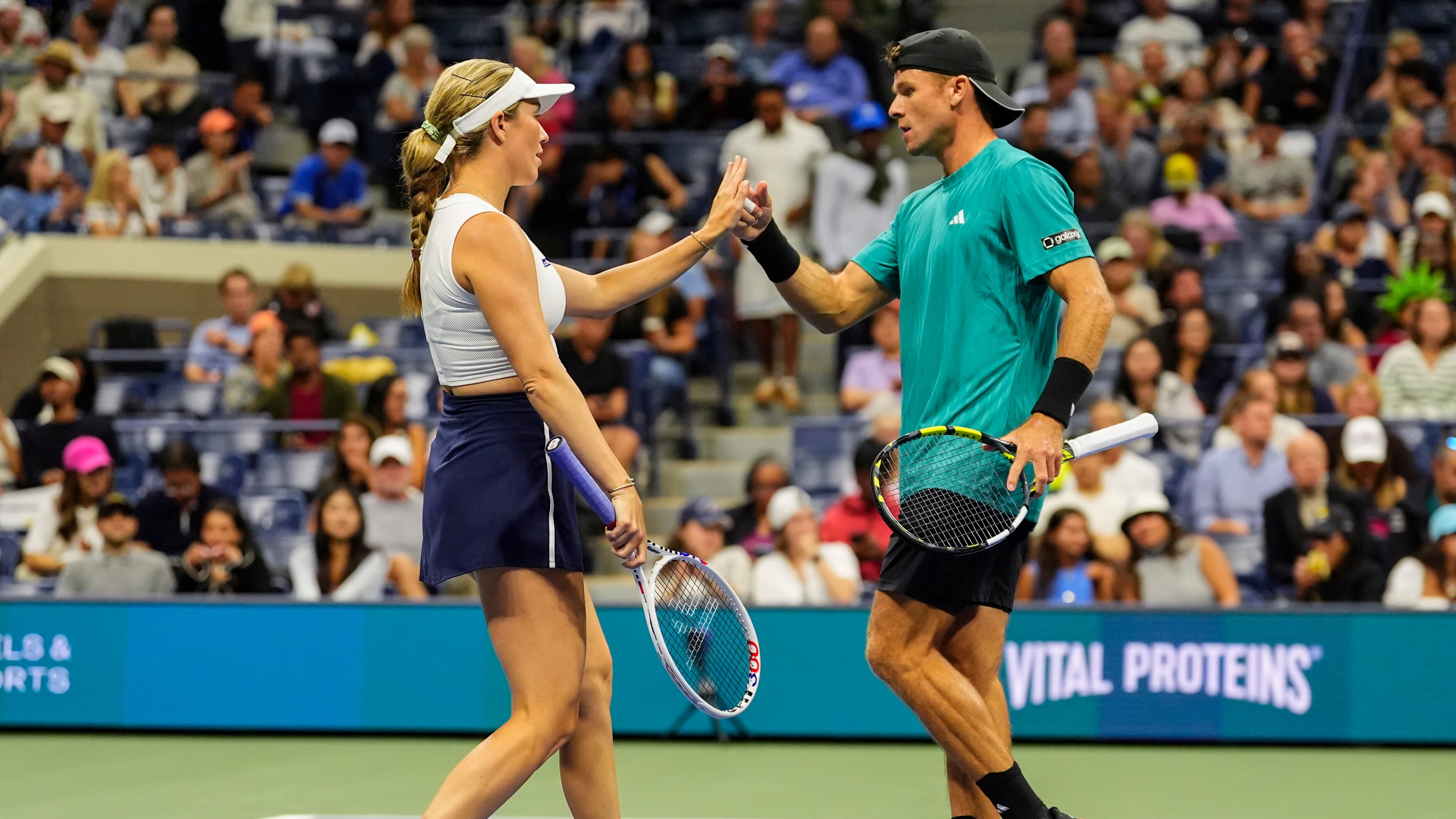 Danielle Collins, right, and Christian Harrison, both of the United States, interact during the mixed doubles semi final at the U.S. Open tennis championships, Wednesday, Aug. 20, 2025, in New York. (AP Photo/Yuki Iwamura)