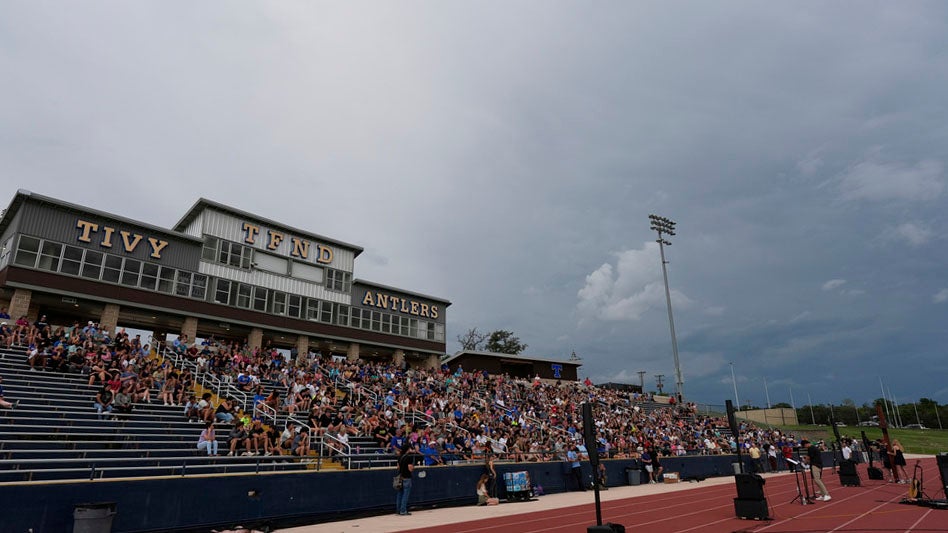 Clouds move in during a vigil for flooding victims at Tivy Antler Stadium on Wednesday, July 9, 2025, in Kerrville, Texas. (AP Photo/Ashley Landis)