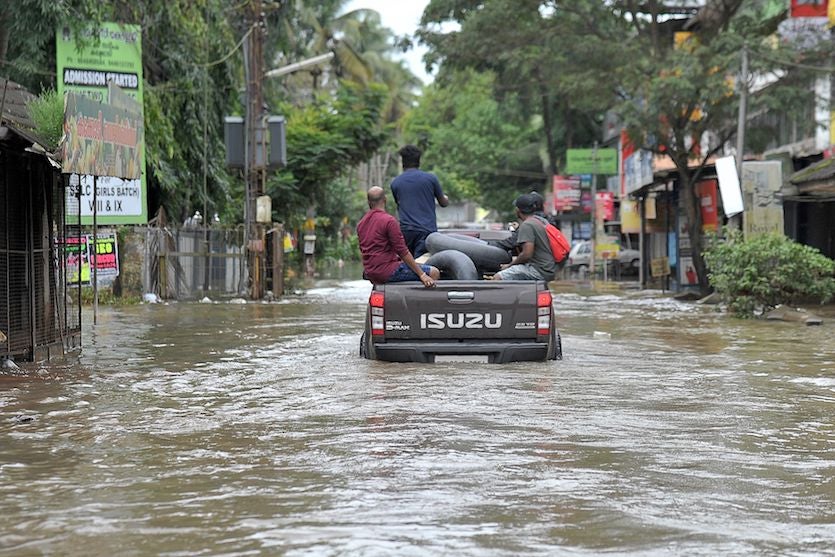 Volunteering members of the Kerala Adventure Sports Club carry flood relief material for marooned villages on the outskirt of Kozhikode district, north of Trivandrum, Kerala, on August 17, 2018 Volunteering members of the Kerala Adventure Sports Club carry flood relief material for marooned villages on the outskirt of Kozhikode district, north of Trivandrum, Kerala, on August 17, 2018