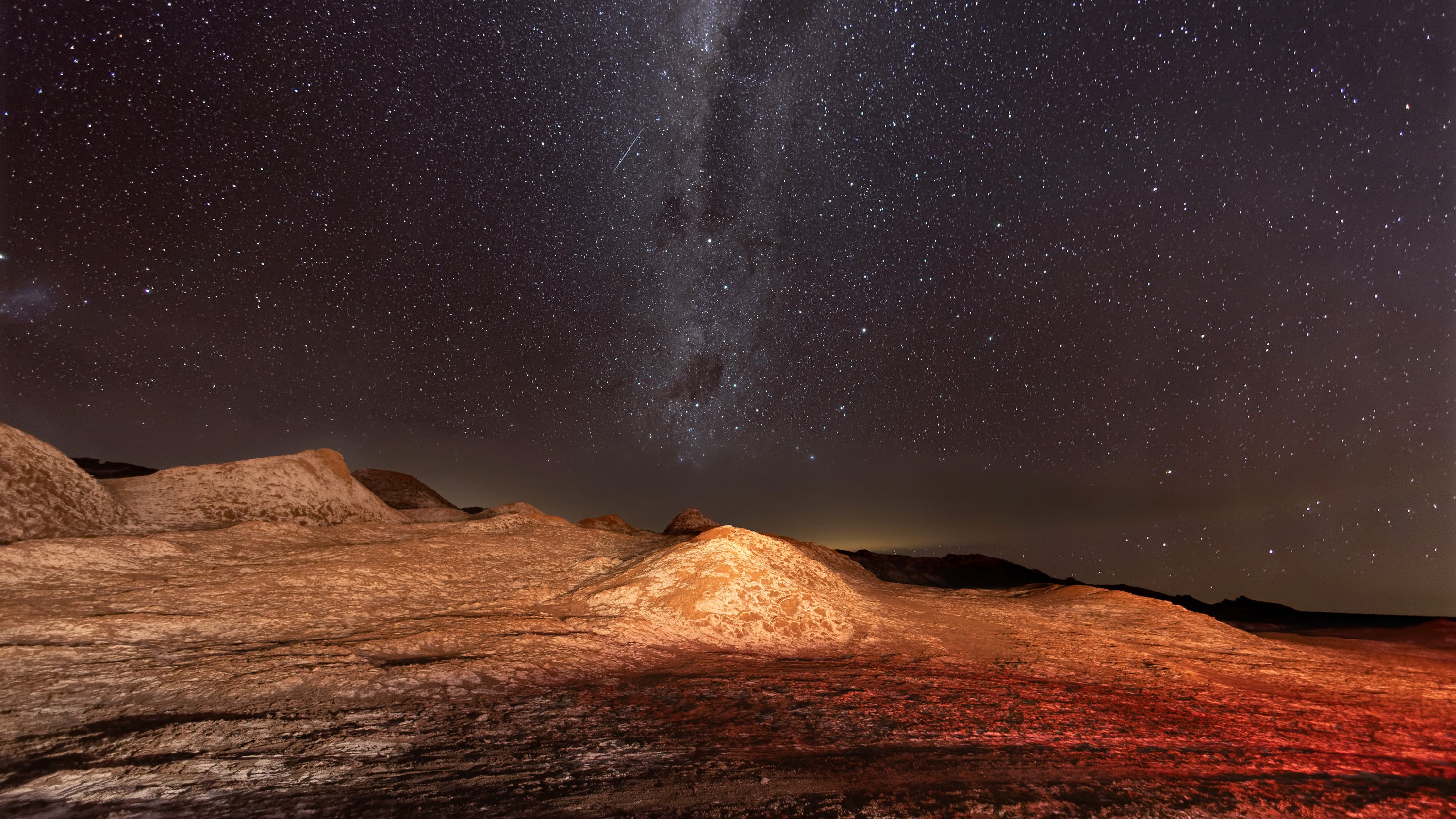 The Milky Way appears over salt formations in the Valle de la Luna in the Atacama Desert, considered the driest place on earth on August 26, 2022 near San Pedro de Atacama, Chile.