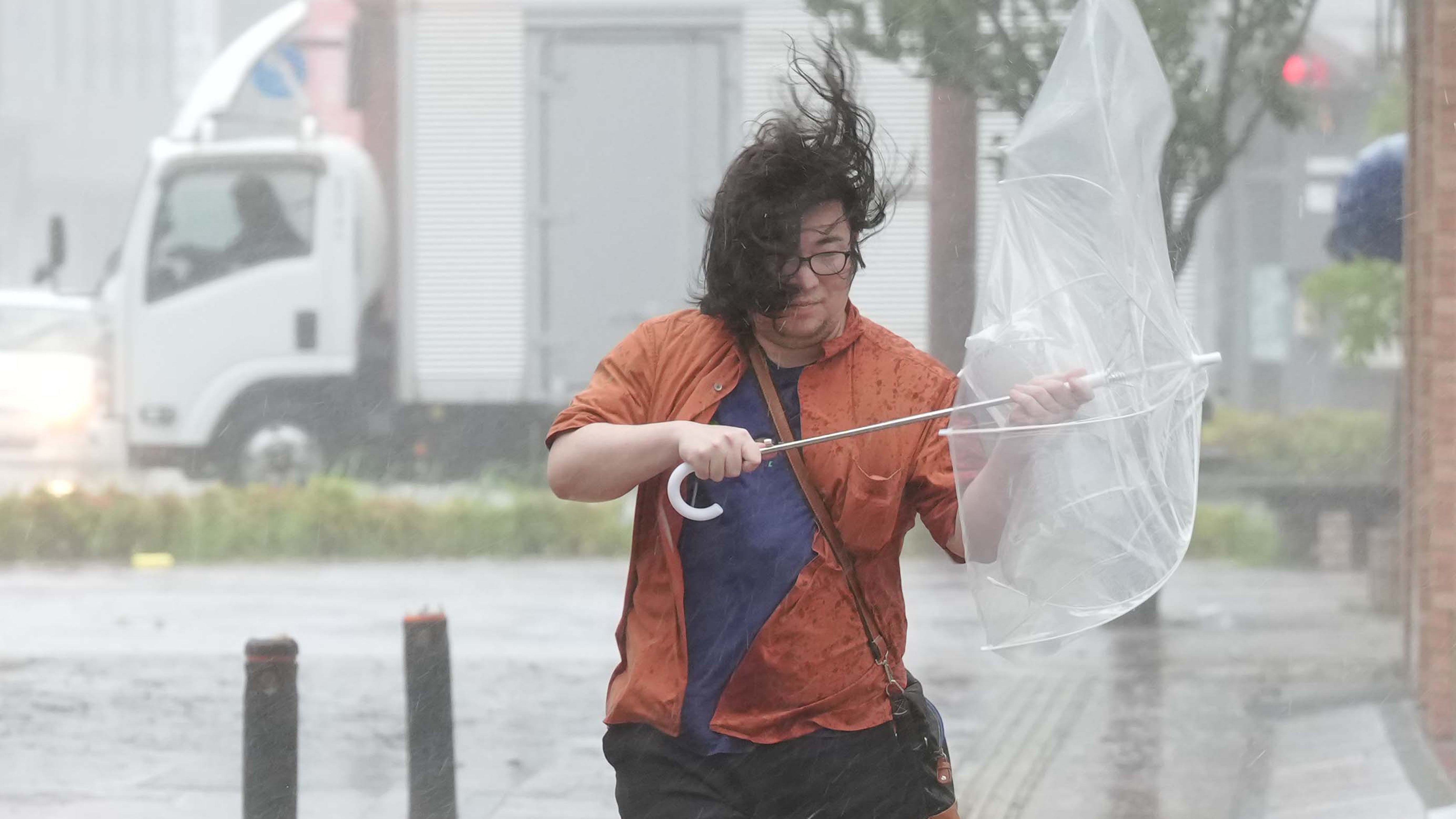 A man walks in strong wind and rain due to Tropical Storm Jangmi, in Miyazaki City, Miyazaki Prefecture, Japan, on June 2, 2026.