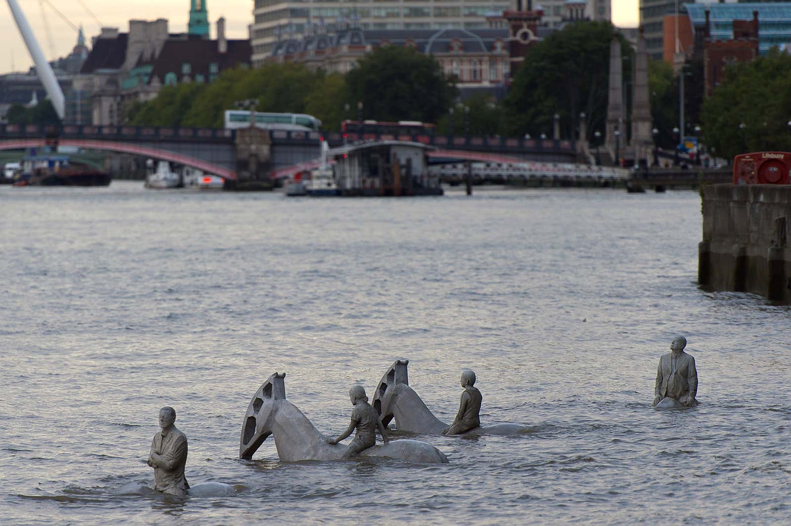 Jason deCaires Taylor's "The Rising Tide" sculptures stand partially submerged in the River Thames in London.