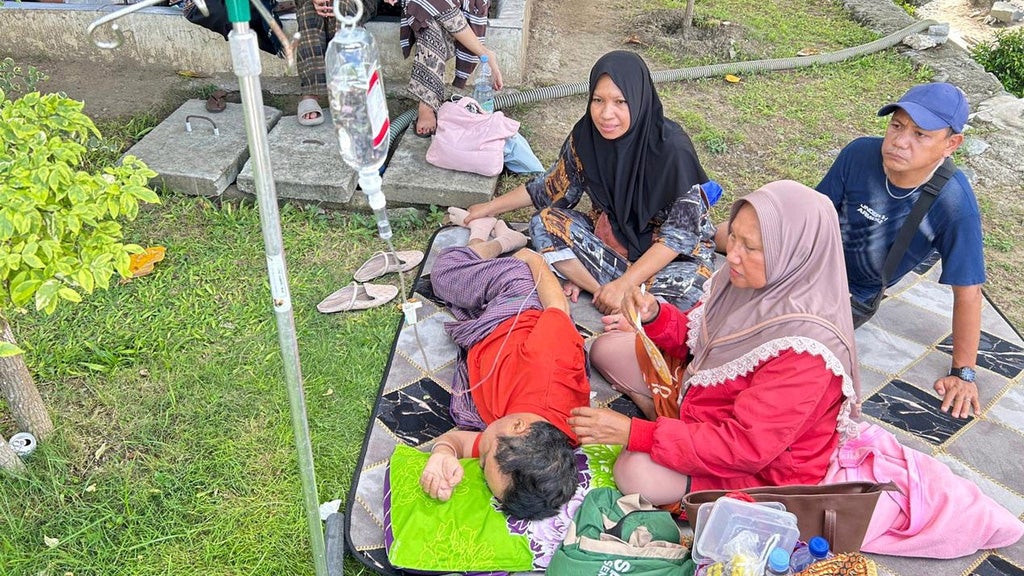 Patients who were evacuated are seen outside of a local hospital following an earthquake in Palu, Central Sulawesi, Tuesday, June 16, 2026. 