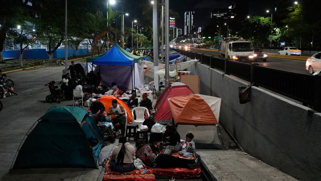 People are camped out with tents on the streets of Caracas, Venezuela, the night after double earthquakes rocked the country.