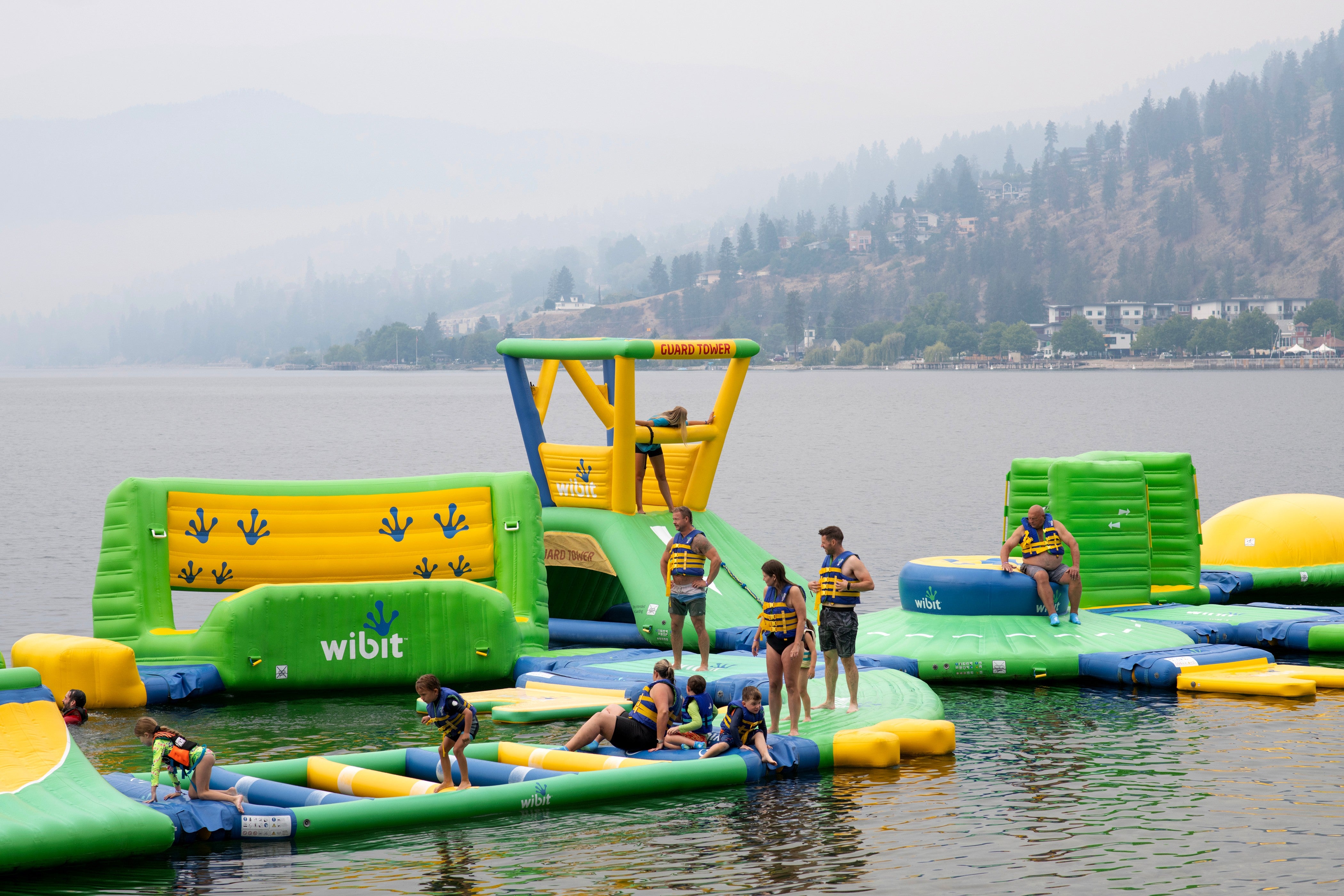 People play at the Peachland Water Park in Peachland, British Columbia, Canada, where evacuation orders due to wildfires were put in place on Saturday, Aug. 8, 2026.