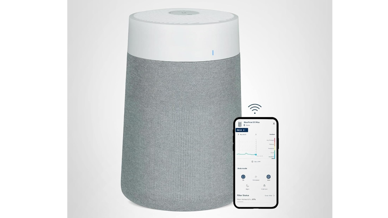 White cylindrical smart air purifier with gray fabric base next to smartphone displaying monitoring app with WiFi connection icon