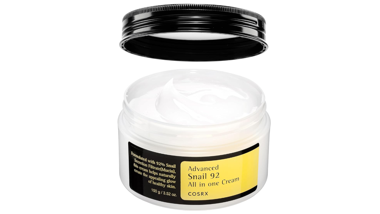 Open jar of COSRX Advanced Snail 92 All in One Cream with black lid removed, showing white cream texture