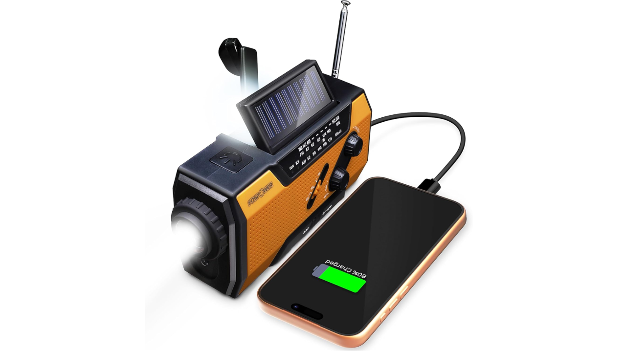 Solar-powered emergency radio with flashlight charging a smartphone on a white background
