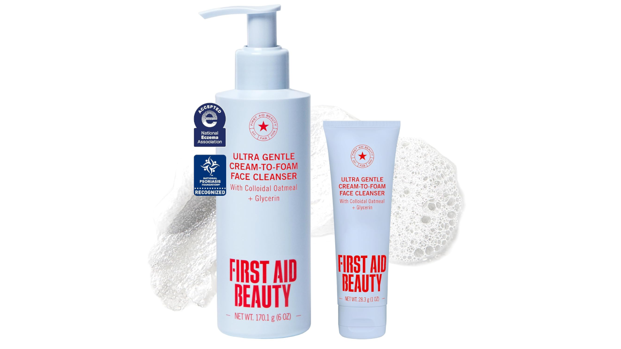 First Aid Beauty Ultra Gentle Cream-to-Foam Face Cleanser pump bottle and travel tube with foam background
