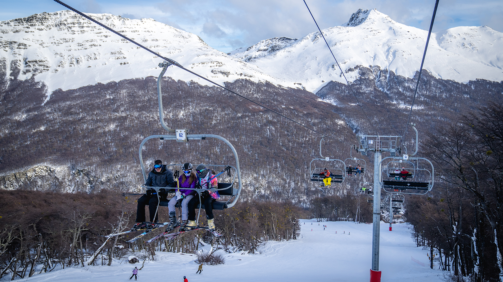 People ride the ski lift at Cerro Castor ski resort during school vacations in Argentina on July 30, 2022.