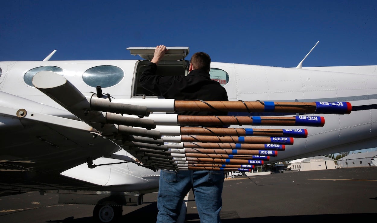This image shows a specially equipped aircraft with burn in flares mounted under each wing containing the silver iodide that is released as the pilots during cloud-seeding. 