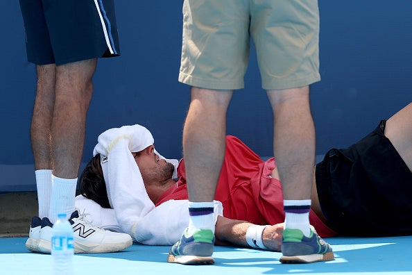 Arthur Rinderknech of France rests on the court for medical attention in his match against Felix Auger-Aliassime of Canada during the Cincinnati Open at Lindner Family Tennis Center on Aug. 11, 2025 in Mason, Ohio.