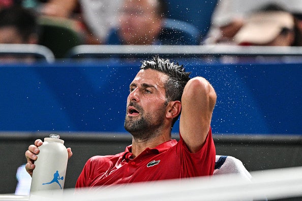 Serbia's Novak Djokovic refreshes himself during his men's singles match against Spain's Jaume Munar at the Shanghai Masters tennis tournament in Shanghai on Oct. 7, 2025.