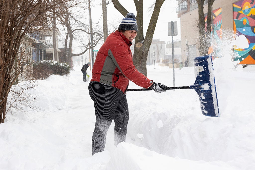 Shoveling knee-deep snow after a major snowstorm in Madison, Wisconsin.